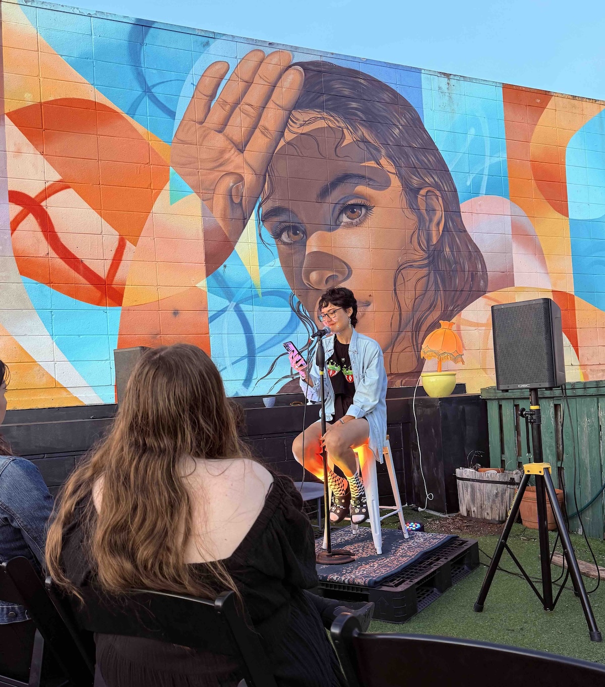 Elina at a community gathering, mid-conversation